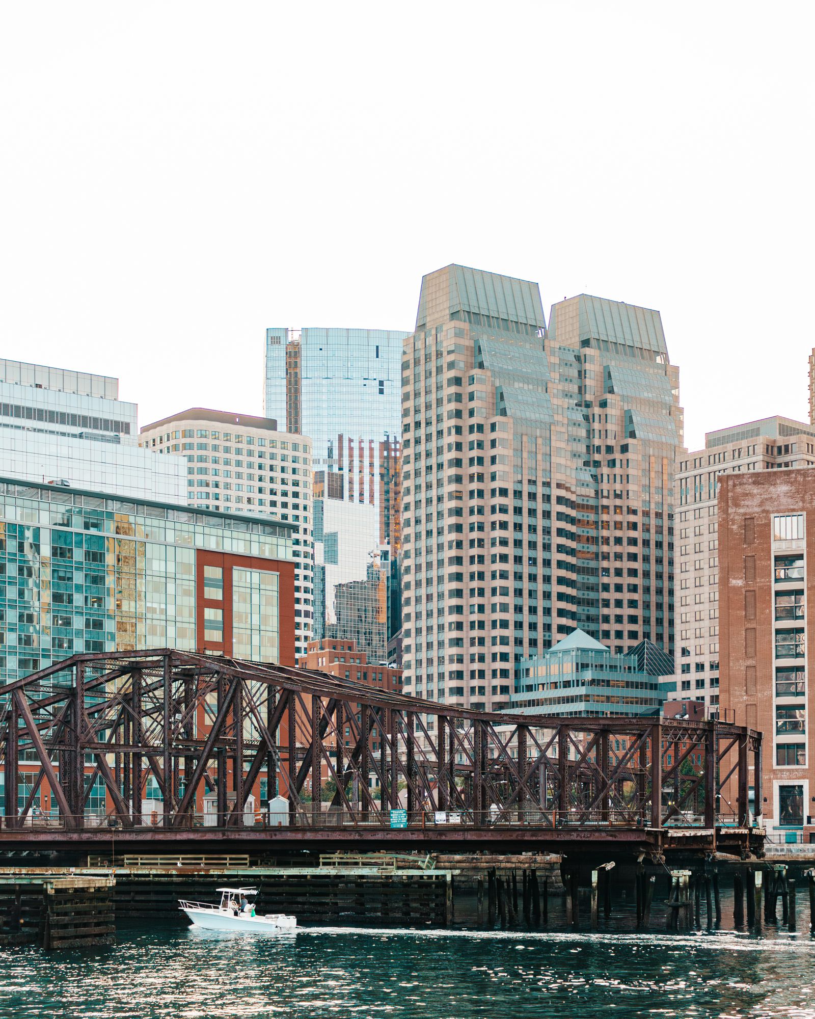 Iron bridge with downtown towers behind