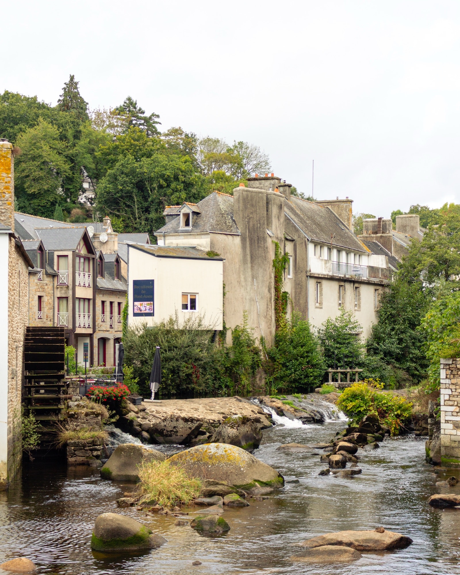 River and stone houses among trees