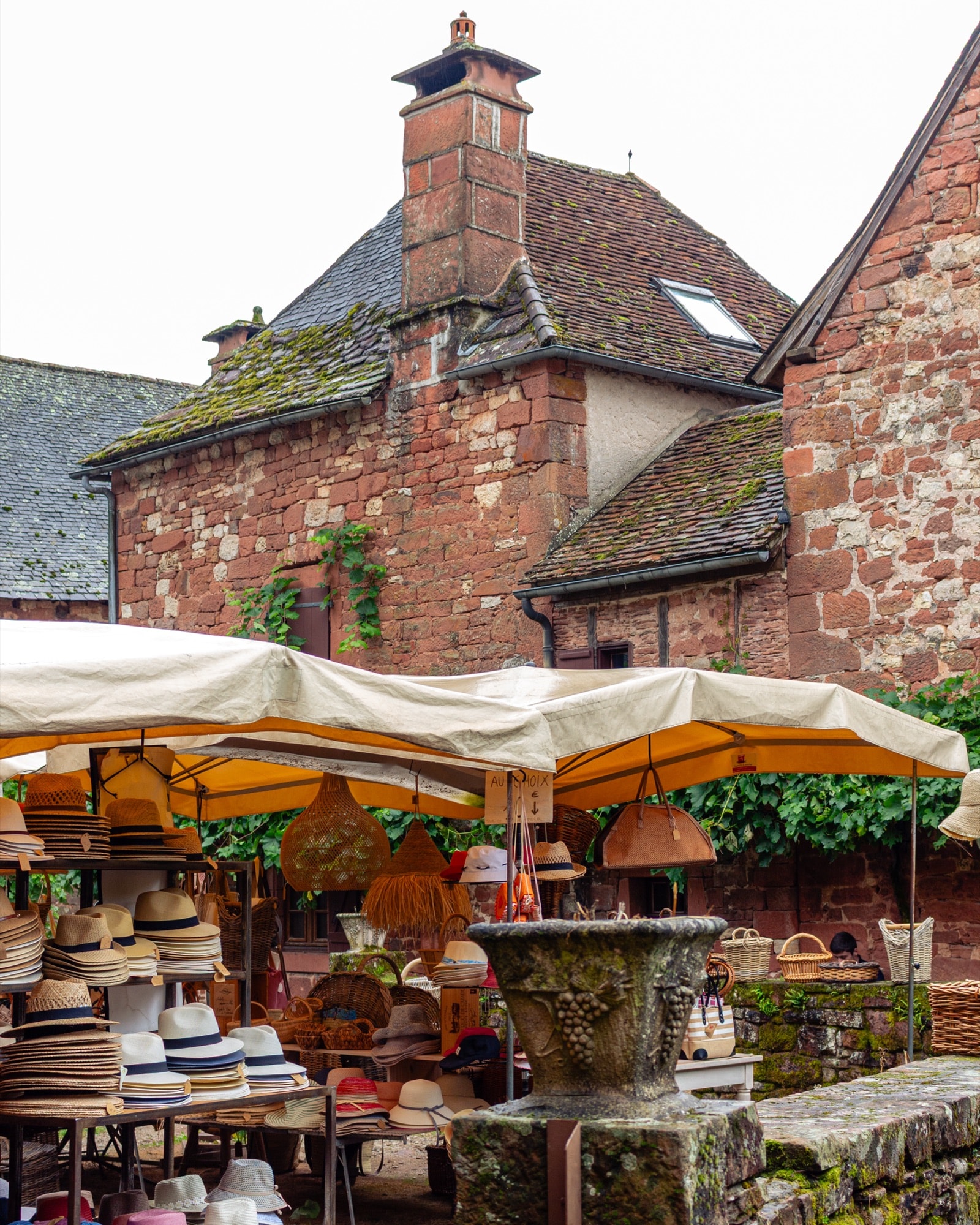 Market stalls under red sandstone walls