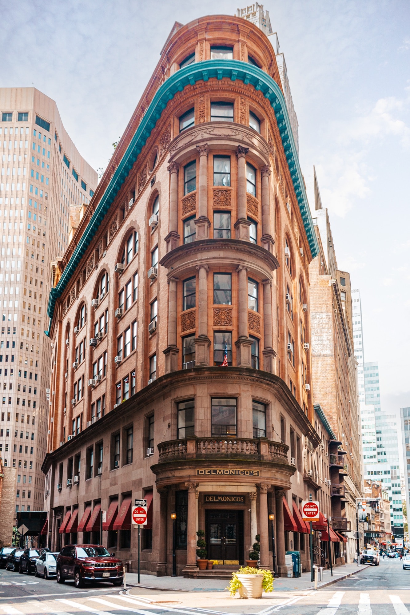 Ornate corner building with a copper crown