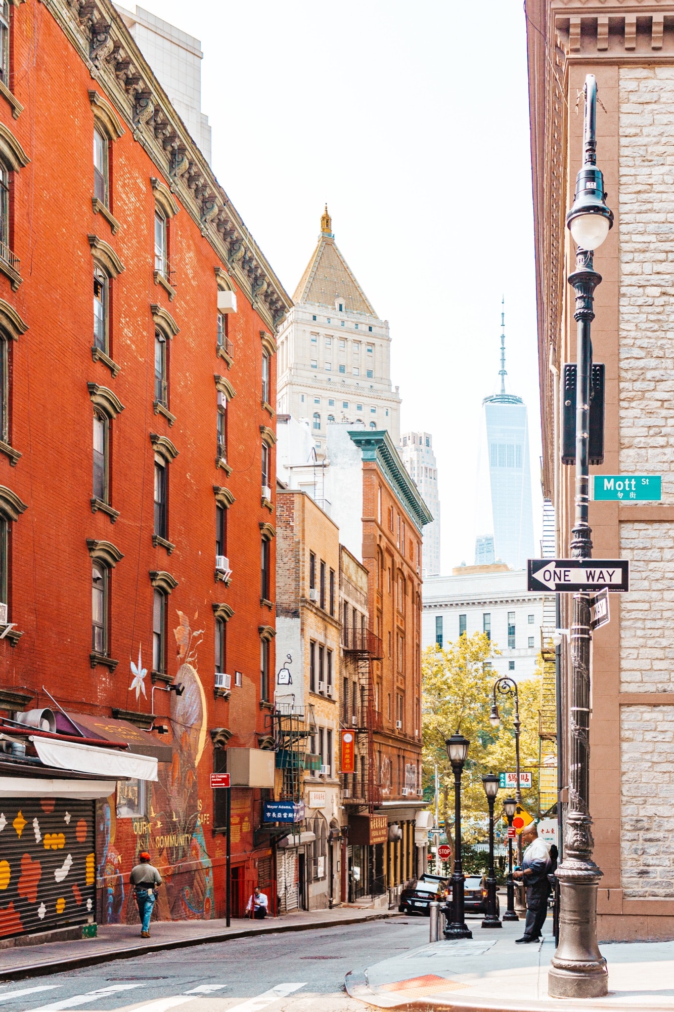 Red-brick street with One World Trade Center in the distance